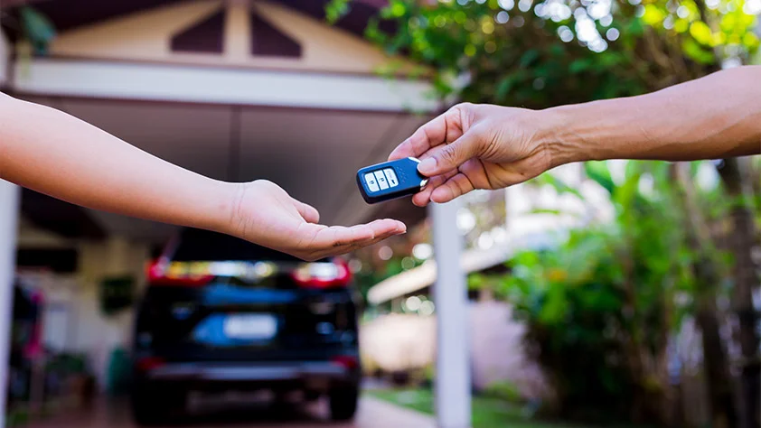 Person handing a key to another person